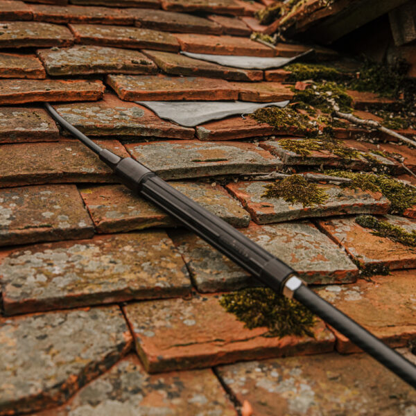 Close up of Kerminator® flexible end tube being directed under roof tiles